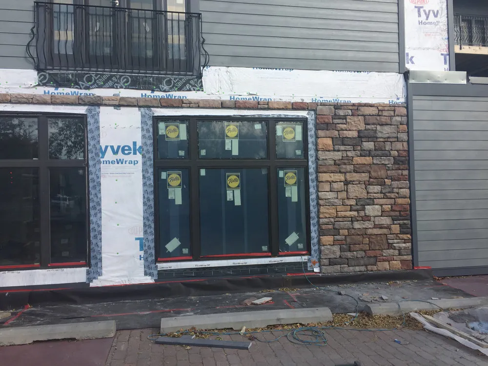 in-process view of a brick facade being added over protective siding wrap